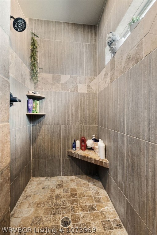 bathroom with a tile shower