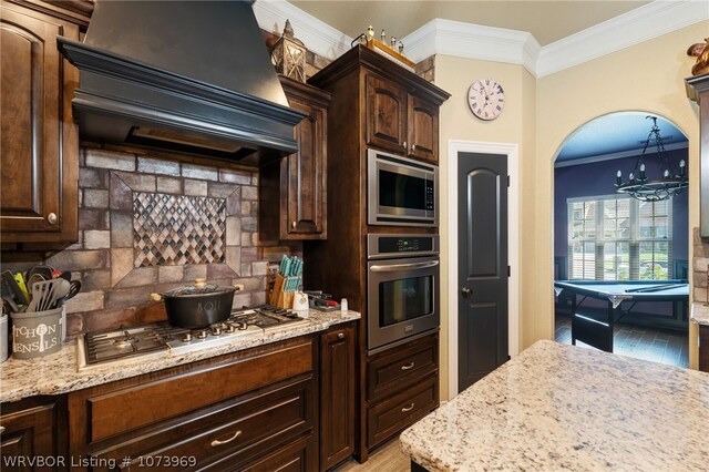 kitchen with premium range hood, crown molding, pool table, appliances with stainless steel finishes, and dark brown cabinets