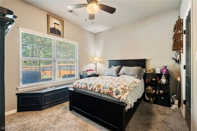 bedroom featuring ceiling fan and light carpet