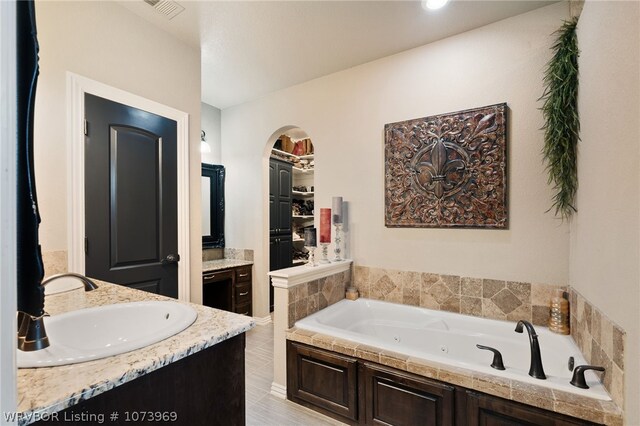 bathroom with a bathtub and vanity