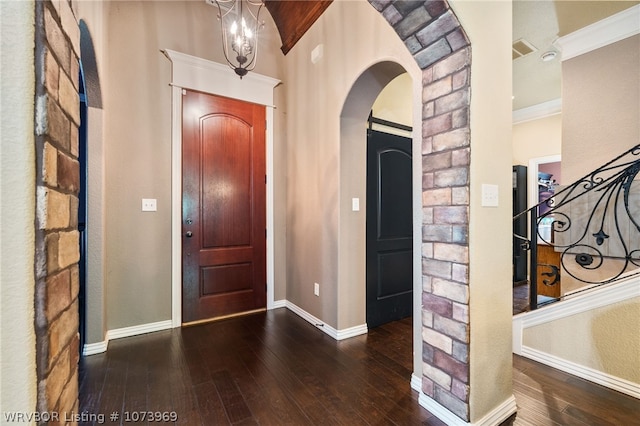 foyer with dark hardwood / wood-style flooring and ornamental molding