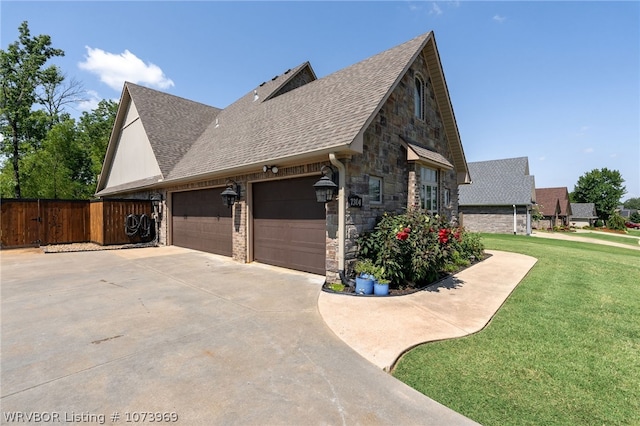 view of home's exterior with a garage and a yard