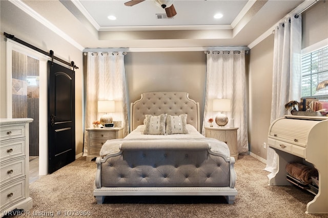 carpeted bedroom featuring a raised ceiling, a barn door, ceiling fan, and crown molding