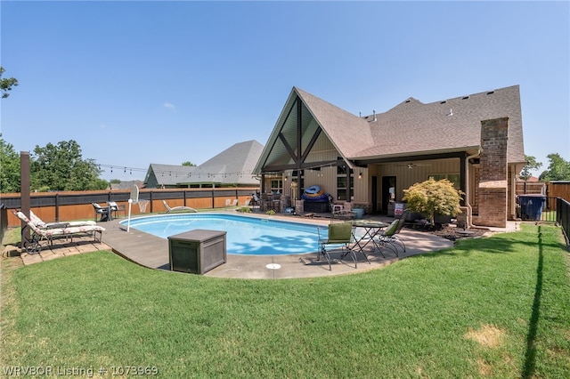 view of swimming pool with a lawn and a patio