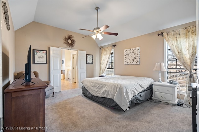 bedroom featuring light colored carpet, vaulted ceiling, and multiple windows