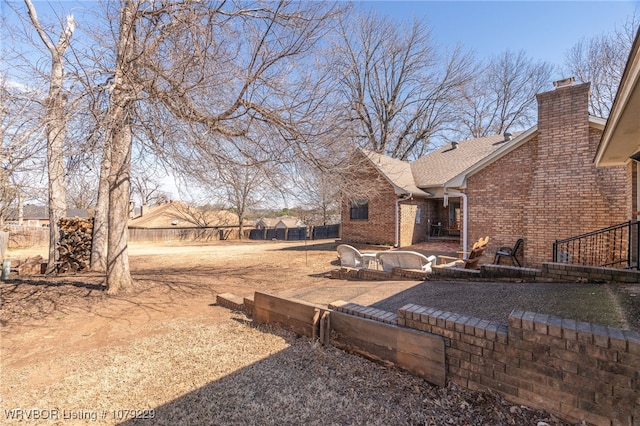 view of yard featuring fence and a patio