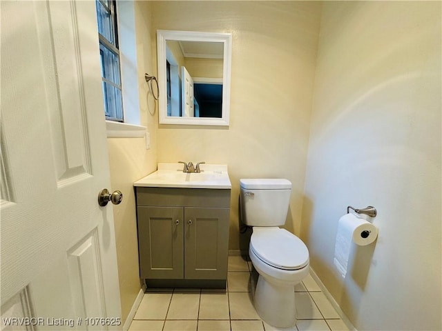 bathroom featuring tile patterned floors, vanity, and toilet