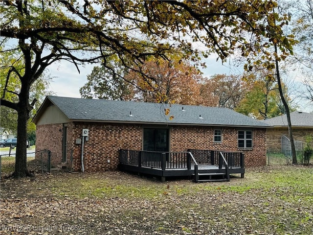 back of house with a deck