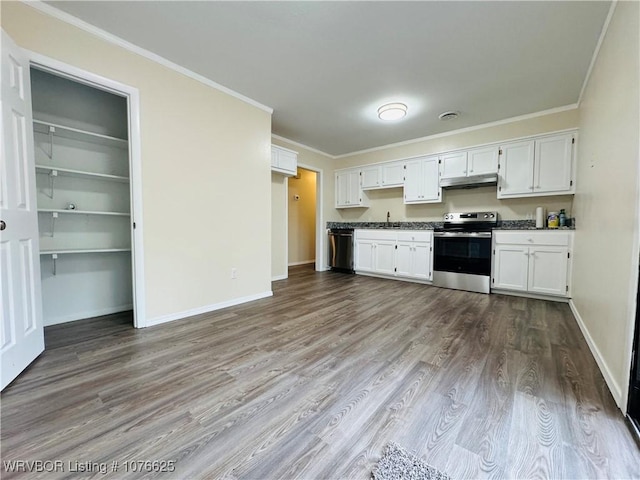 kitchen with appliances with stainless steel finishes, white cabinetry, crown molding, and hardwood / wood-style floors