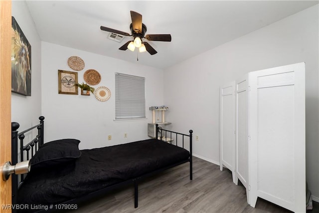 bedroom featuring ceiling fan and wood-type flooring