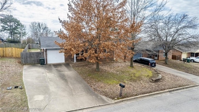 view of property hidden behind natural elements featuring a garage