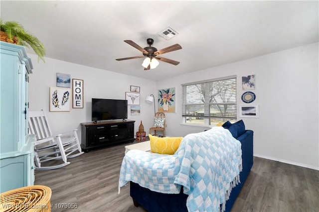 living room featuring ceiling fan and dark hardwood / wood-style floors