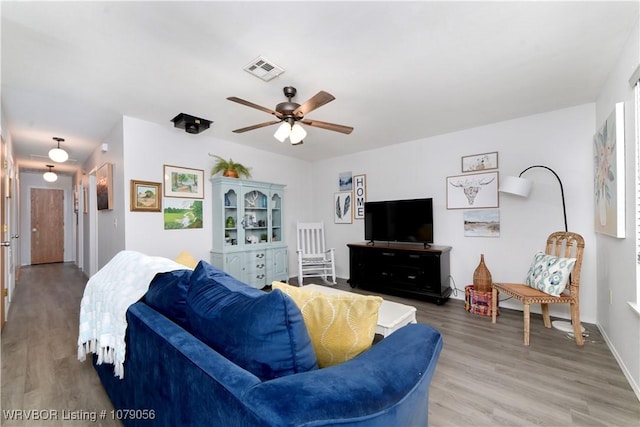 living room featuring hardwood / wood-style flooring and ceiling fan