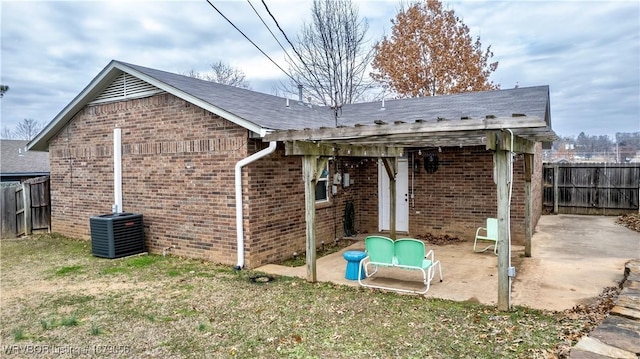 view of property exterior featuring a patio area, central air condition unit, and a lawn