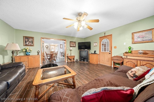 living room with ceiling fan and a textured ceiling