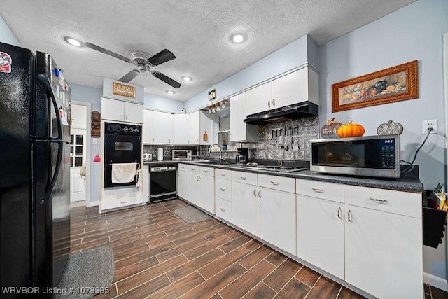 kitchen with a textured ceiling, black appliances, white cabinetry, decorative backsplash, and sink