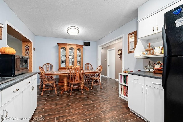 dining space with a textured ceiling