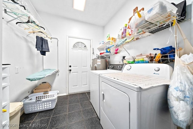 clothes washing area with washer and clothes dryer and water heater