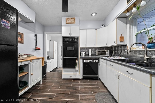 kitchen with a textured ceiling, white cabinets, black appliances, tasteful backsplash, and sink