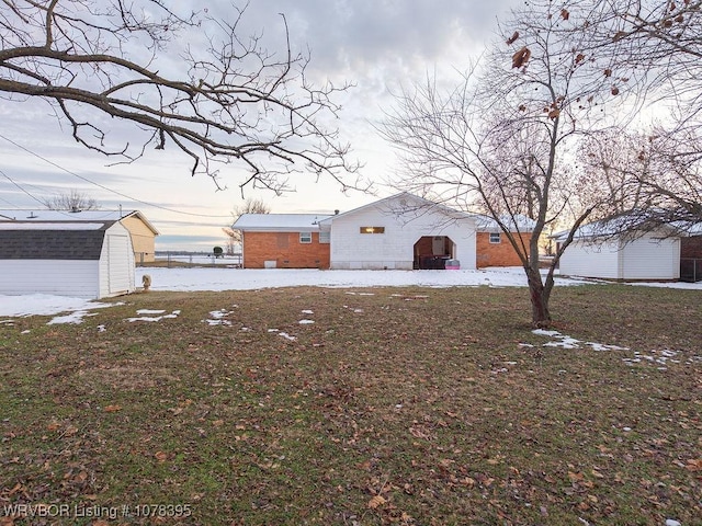 view of front of home featuring a storage unit