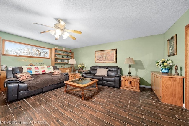 living room featuring ceiling fan and a textured ceiling