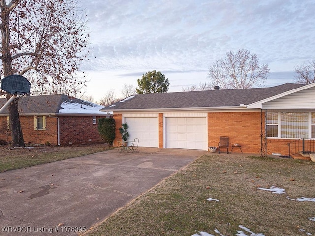 property exterior at dusk with a garage and a yard