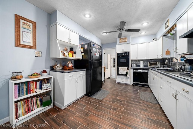 kitchen featuring a textured ceiling, sink, white cabinets, and black appliances