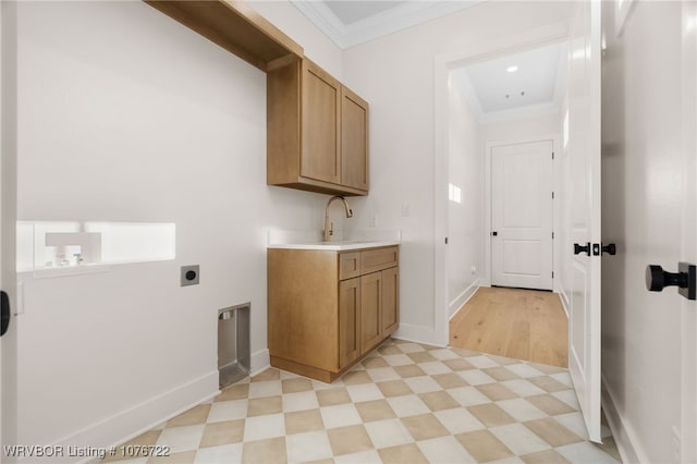 washroom with electric dryer hookup, cabinets, sink, crown molding, and hookup for a washing machine