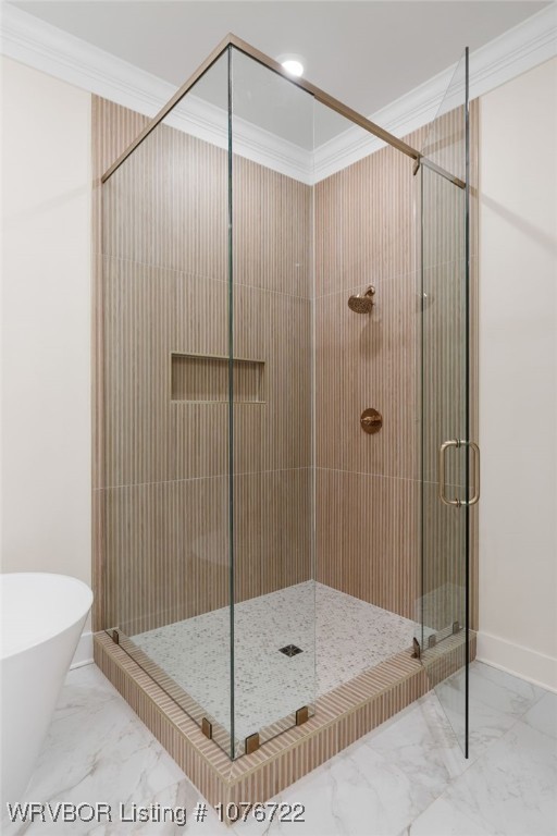 bathroom featuring separate shower and tub and ornamental molding