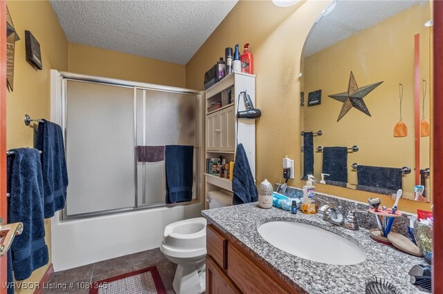461510 E 1130th Rd, Sallisaw, OK 74955 - full bathroom featuring a textured ceiling, vanity, toilet, enclosed tub / shower combo, and tile patterned floors