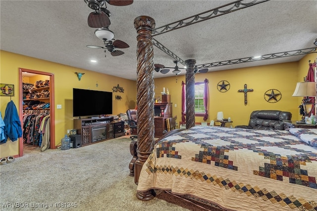 461510 E 1130th Rd, Sallisaw, OK 74955 - carpeted bedroom featuring a walk in closet, a textured ceiling, and a ceiling fan