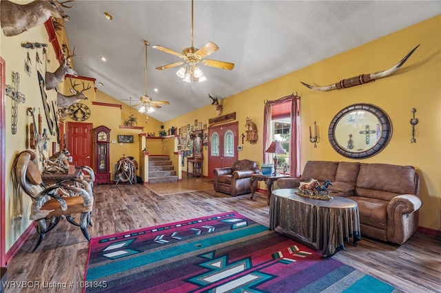461510 E 1130th Rd, Sallisaw, OK 74955 - living room featuring wood finished floors, a ceiling fan, stairway, high vaulted ceiling, and baseboards