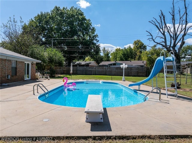 1414 12th Cir, Barling, AR 72923 - view of pool featuring a water slide, a diving board, a patio area, and a fenced backyard