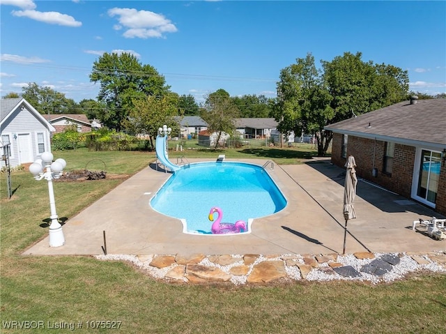 1414 12th Cir, Barling, AR 72923 - view of swimming pool featuring a water slide, a lawn, and a patio area