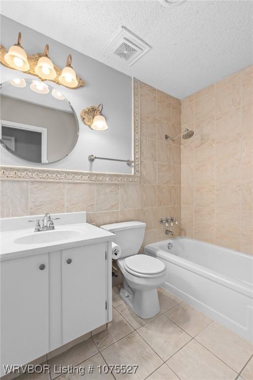 1414 12th Cir, Barling, AR 72923 - bathroom featuring tile walls, vanity, a textured ceiling, tile patterned flooring, and bathing tub / shower combination