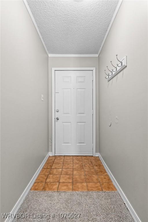 1414 12th Cir, Barling, AR 72923 - doorway featuring a textured ceiling, tile patterned floors, and crown molding