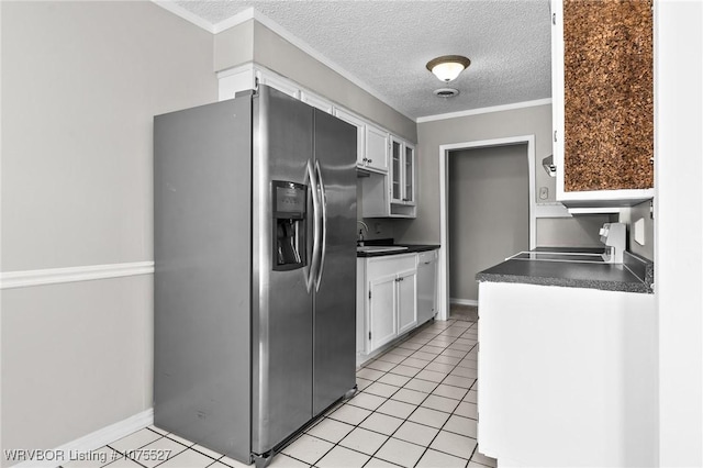 1414 12th Cir, Barling, AR 72923 - kitchen featuring stainless steel appliances, white cabinets, dark countertops, light tile patterned floors, and a textured ceiling