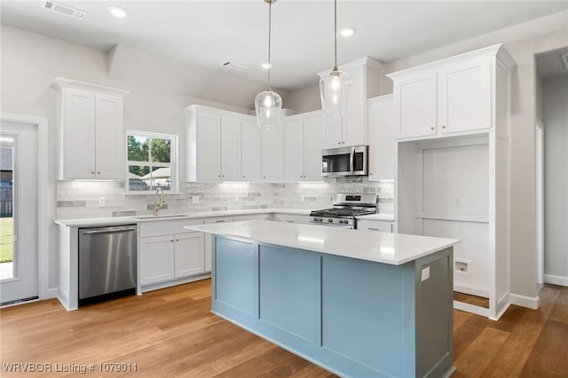 kitchen with white cabinetry, appliances with stainless steel finishes, and sink