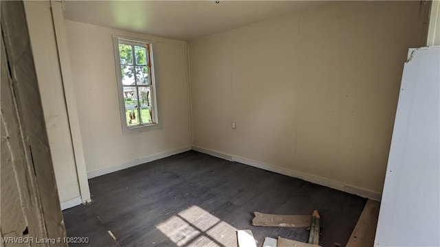 23 Church St, Charleston, AR 72933 - empty room with wood finished floors and baseboards