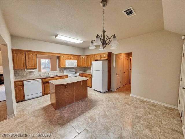 199 Pecan Ln, Greenwood, AR 72936 - kitchen featuring white appliances, visible vents, a chandelier, a center island, and light countertops