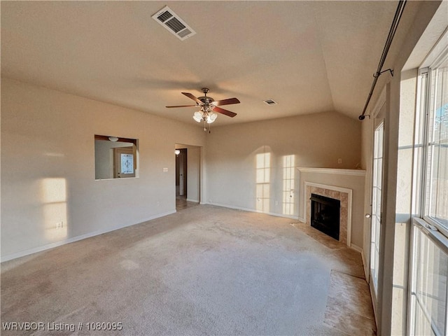 199 Pecan Ln, Greenwood, AR 72936 - unfurnished living room featuring visible vents, ceiling fan, carpet, a tile fireplace, and lofted ceiling