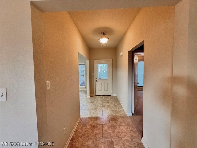 199 Pecan Ln, Greenwood, AR 72936 - hallway with visible vents, light tile patterned floors, baseboards, and a textured wall