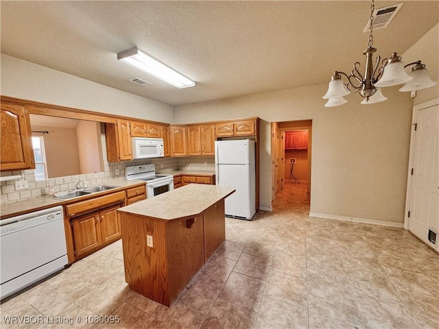 199 Pecan Ln, Greenwood, AR 72936 - kitchen with white appliances, visible vents, light countertops, a sink, and backsplash