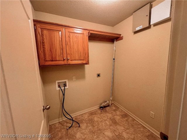 199 Pecan Ln, Greenwood, AR 72936 - clothes washing area with baseboards, electric dryer hookup, a textured ceiling, hookup for a washing machine, and cabinet space