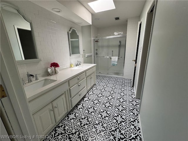 1721 Armistead Rd, Fort Smith, AR 72916 - bathroom featuring a skylight, a shower stall, double vanity, and backsplash