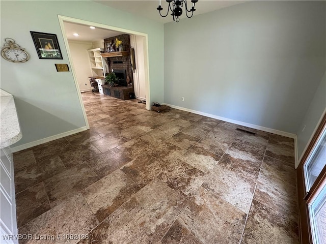 1721 Armistead Rd, Fort Smith, AR 72916 - unfurnished dining area with a chandelier, stone tile floors, and a fireplace