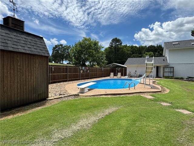 1721 Armistead Rd, Fort Smith, AR 72916 - view of swimming pool with a water slide, a fenced backyard, a diving board, and a storage shed
