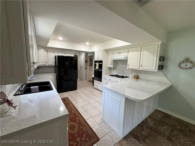 1721 Armistead Rd, Fort Smith, AR 72916 - kitchen featuring black appliances, a raised ceiling, a peninsula, white cabinetry, and under cabinet range hood