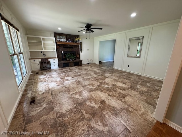1721 Armistead Rd, Fort Smith, AR 72916 - unfurnished living room featuring ceiling fan and a brick fireplace