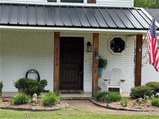 1721 Armistead Rd, Fort Smith, AR 72916 - view of exterior entry featuring brick siding, covered porch, and a metal roof